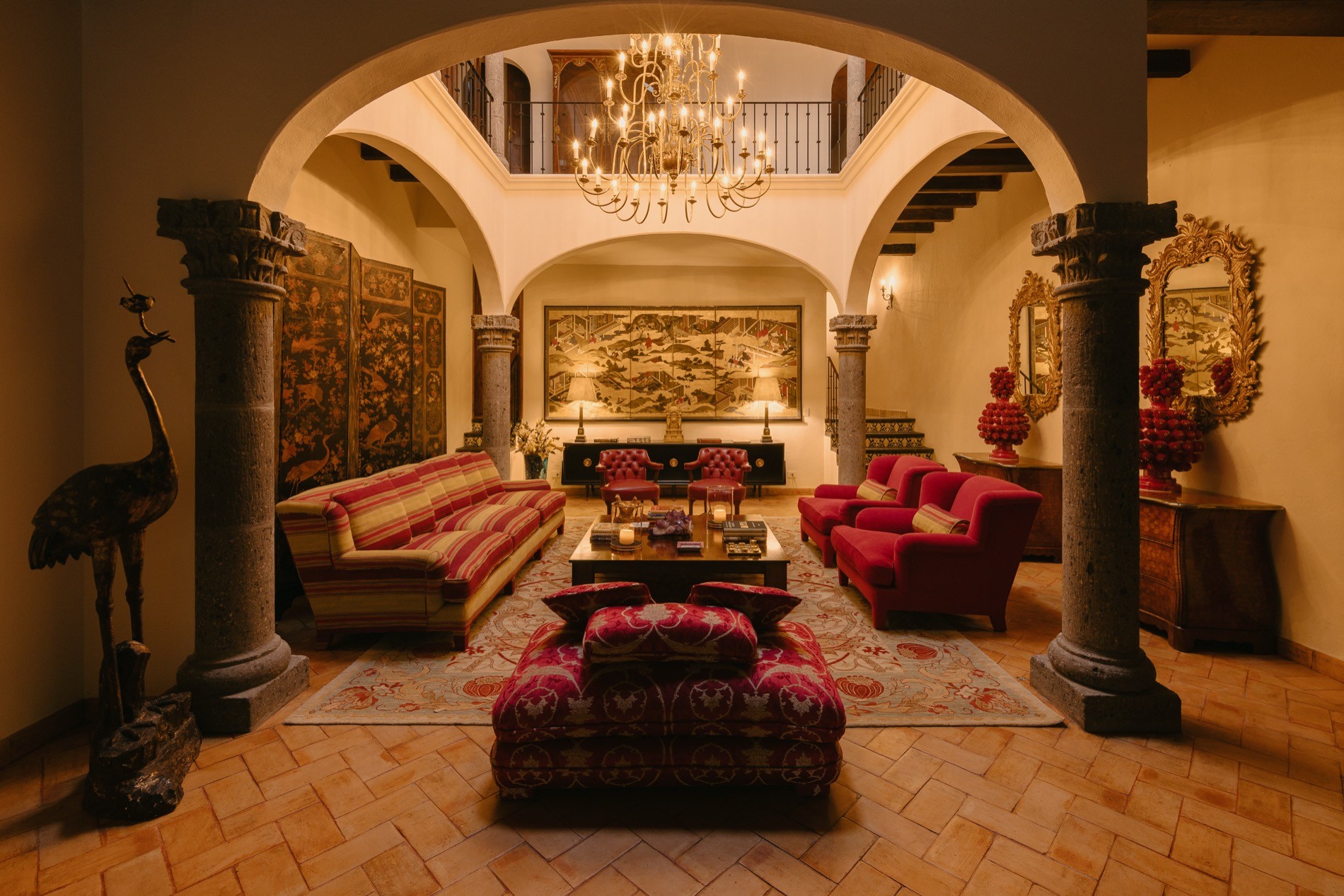 La Residencia San Miguel de Allende, colonial villa exterior at dusk with illuminated stone archways, lush gardens, and bugambilia