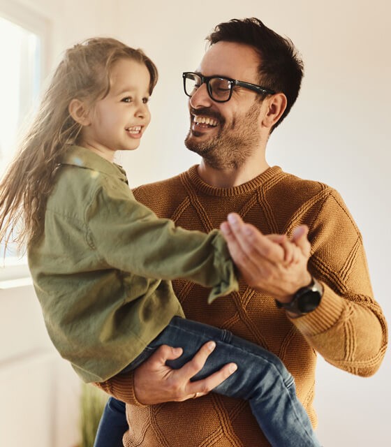 man holding his smiling daughter