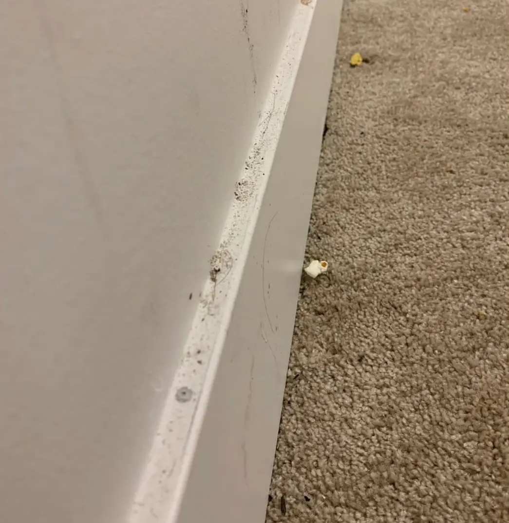 Dirty baseboard with grime and residue before a deep clean.