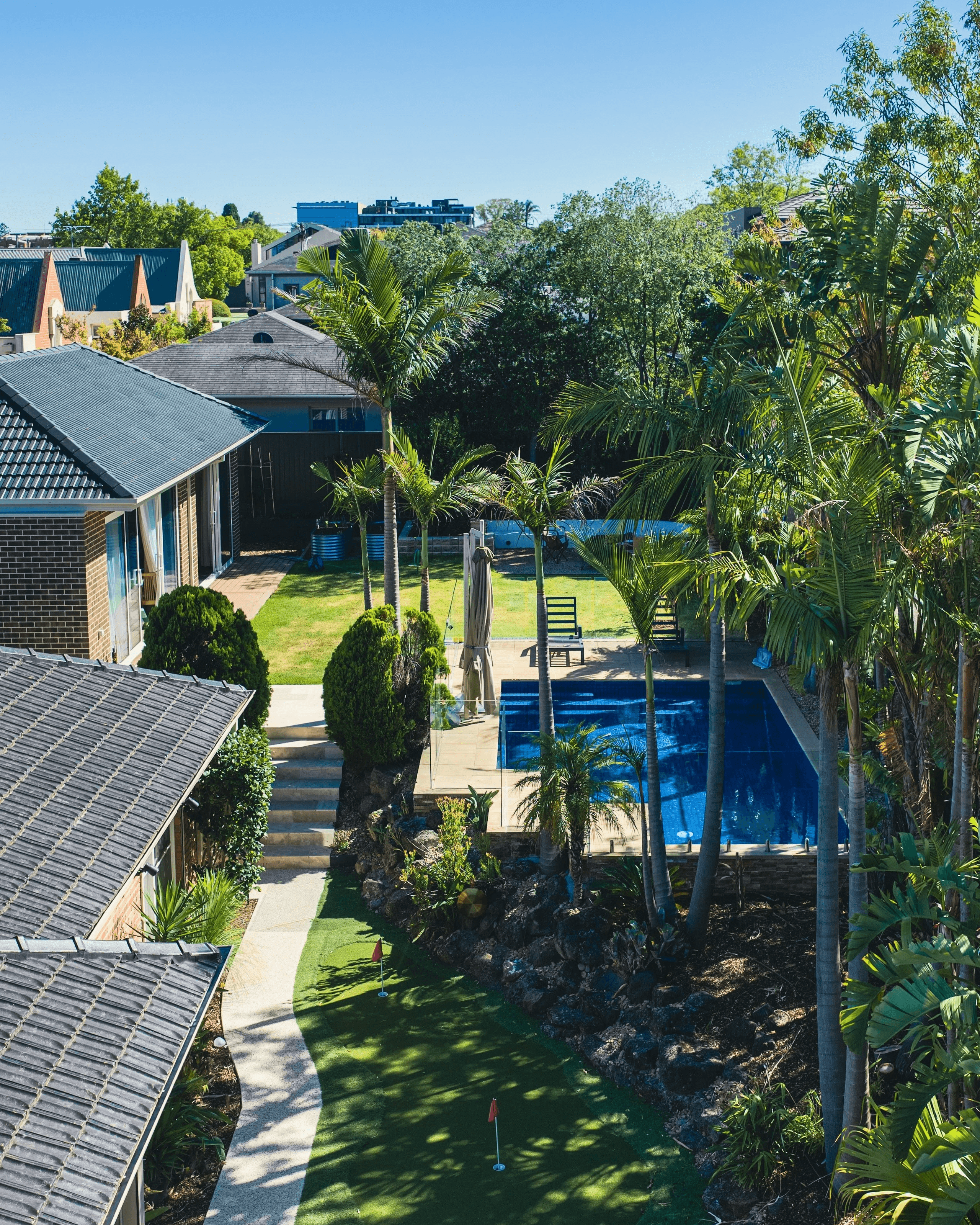A modern building with a curved facade and trees growing in the courtyard