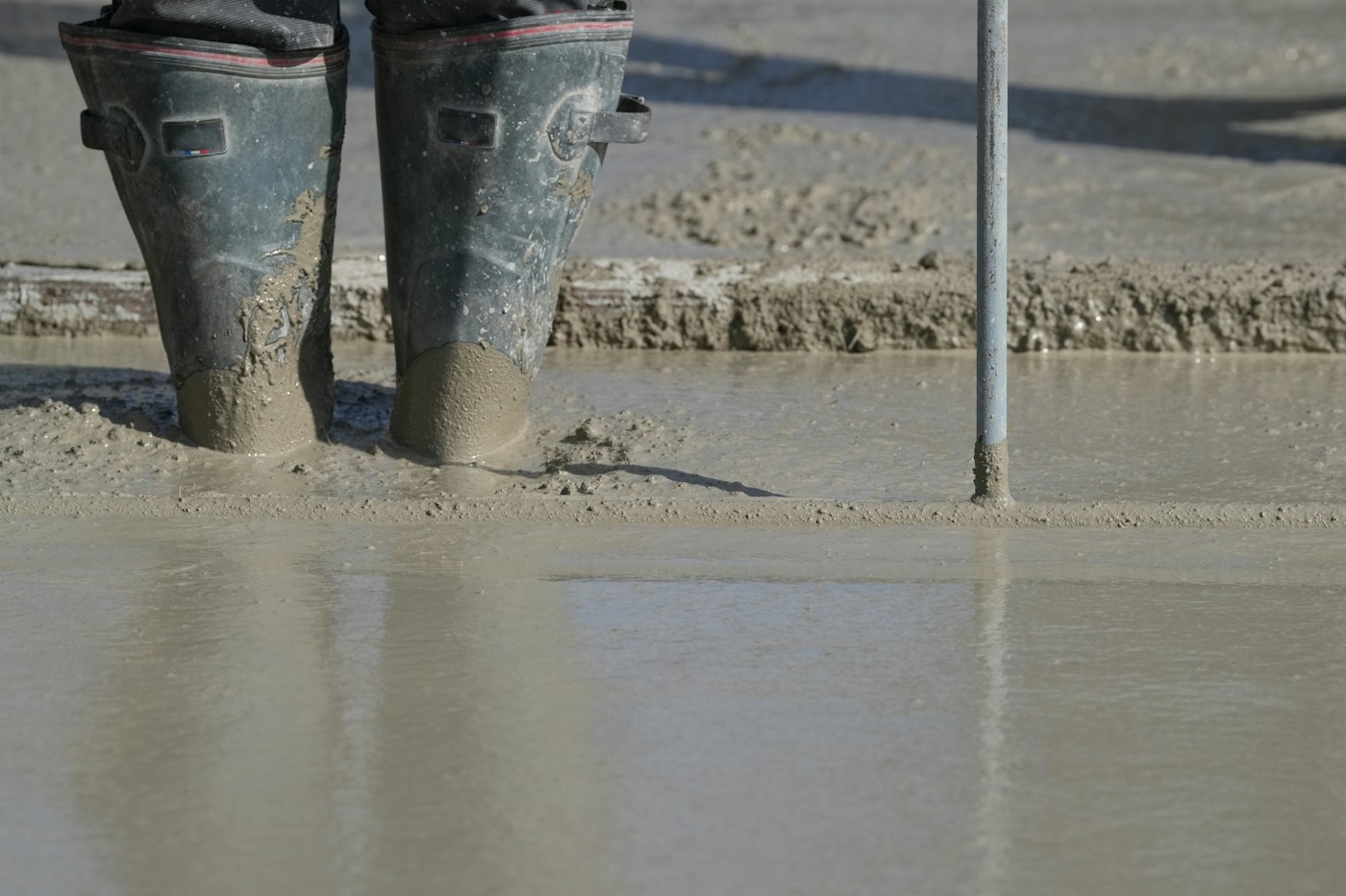 Worker standing in freshly poured concrete
