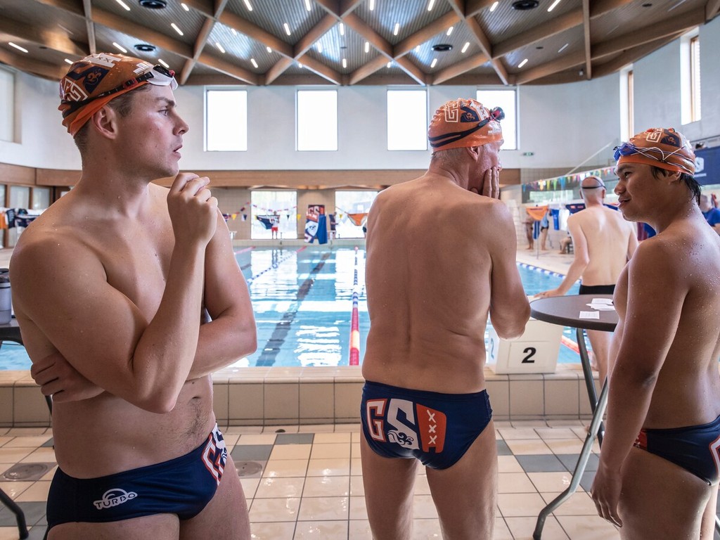 Two people stretching on yoga mats