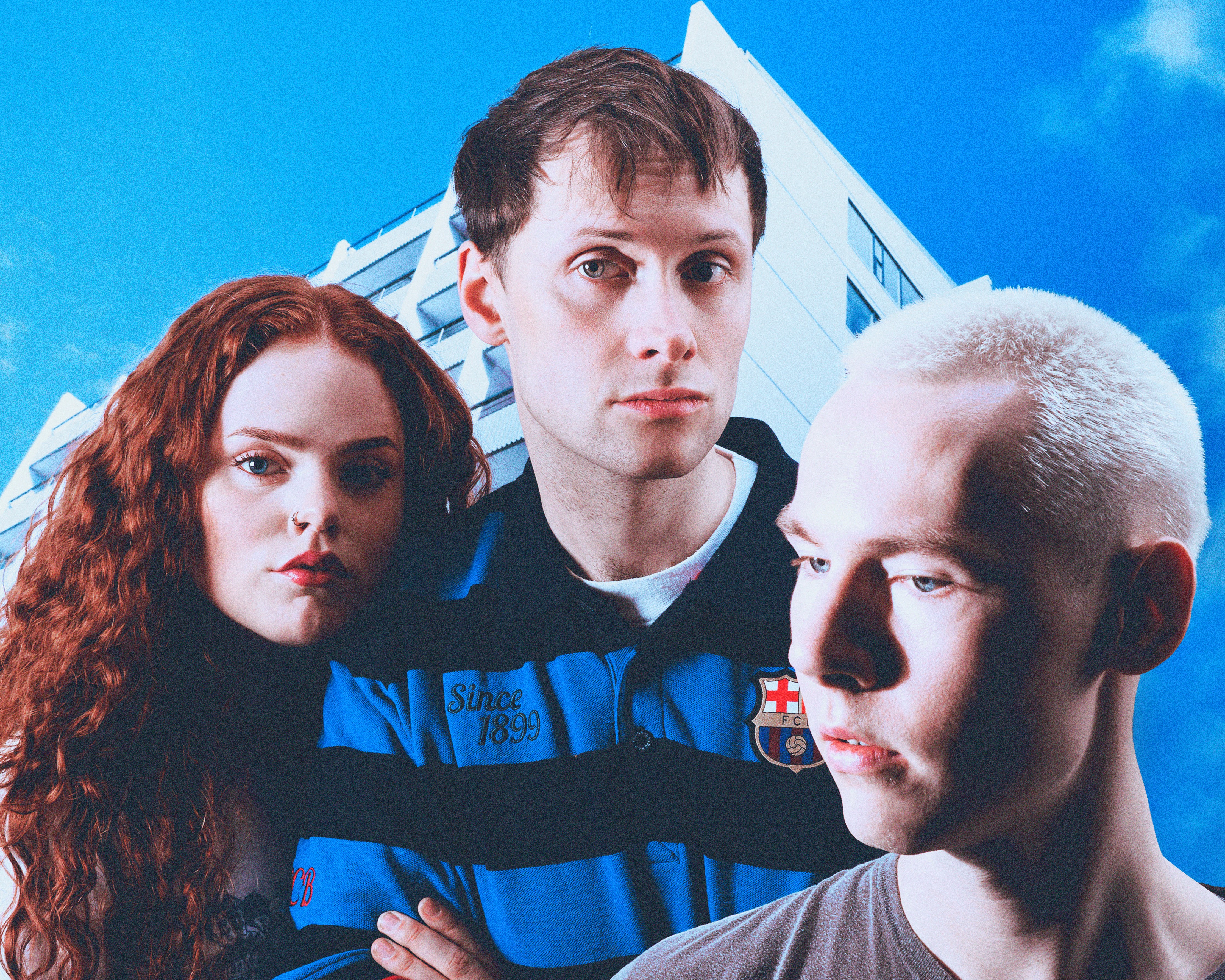 Black-and-white portrait of Icelandic band Spacestation standing next to concrete wall.