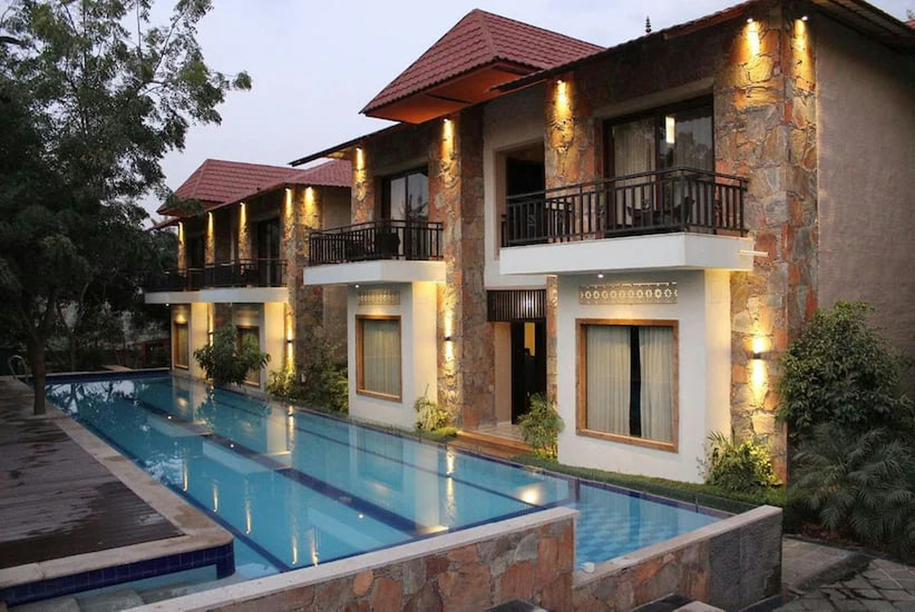 a house with a swimming pool in front of it