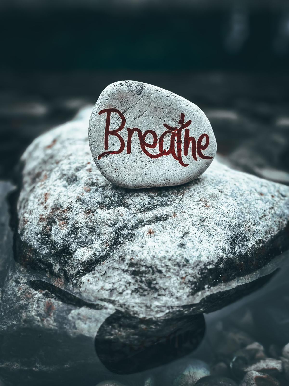 A pebble with the word "breathe" written on it.