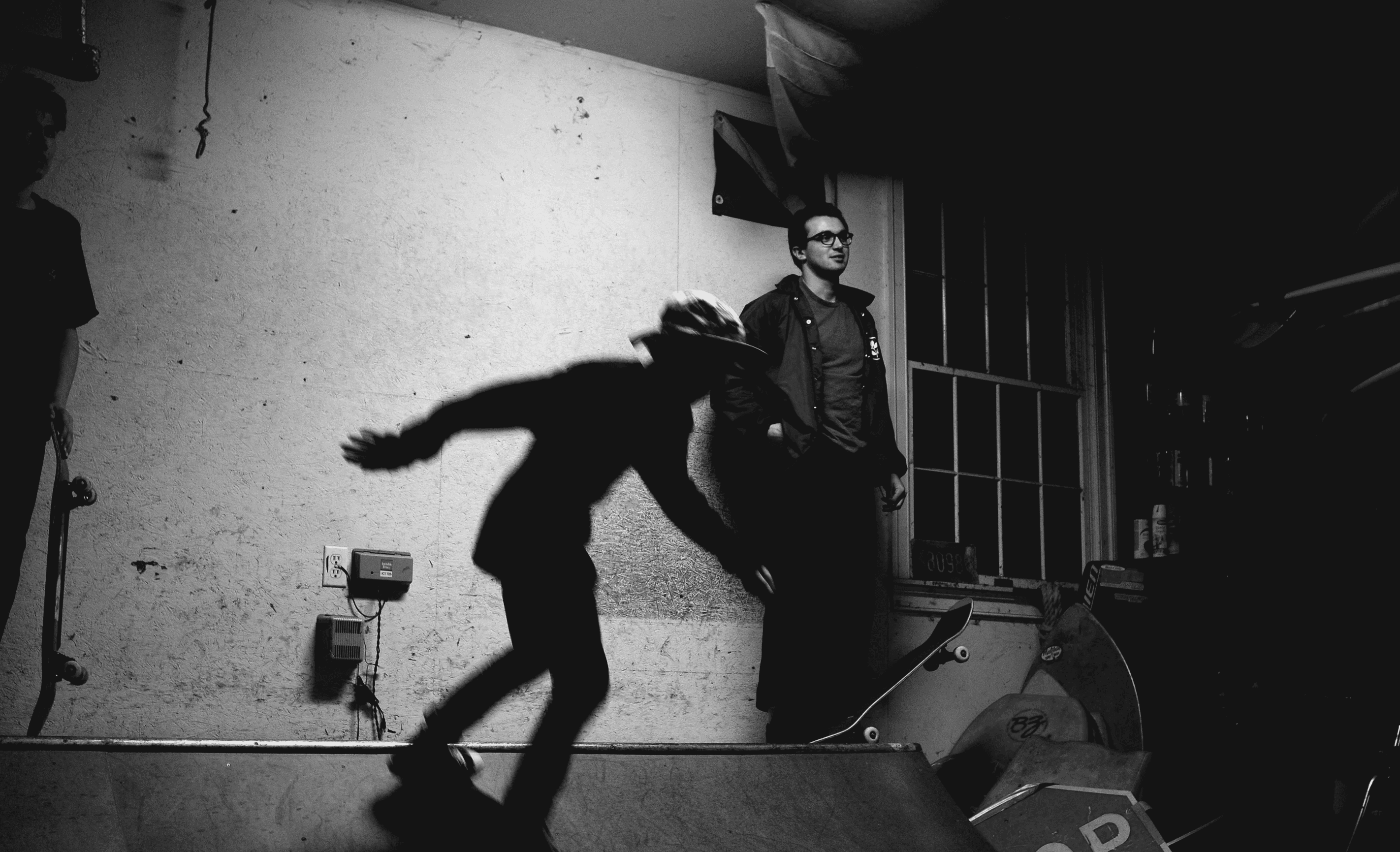 Digital photography of skateboarders on a halfpipe in a garage