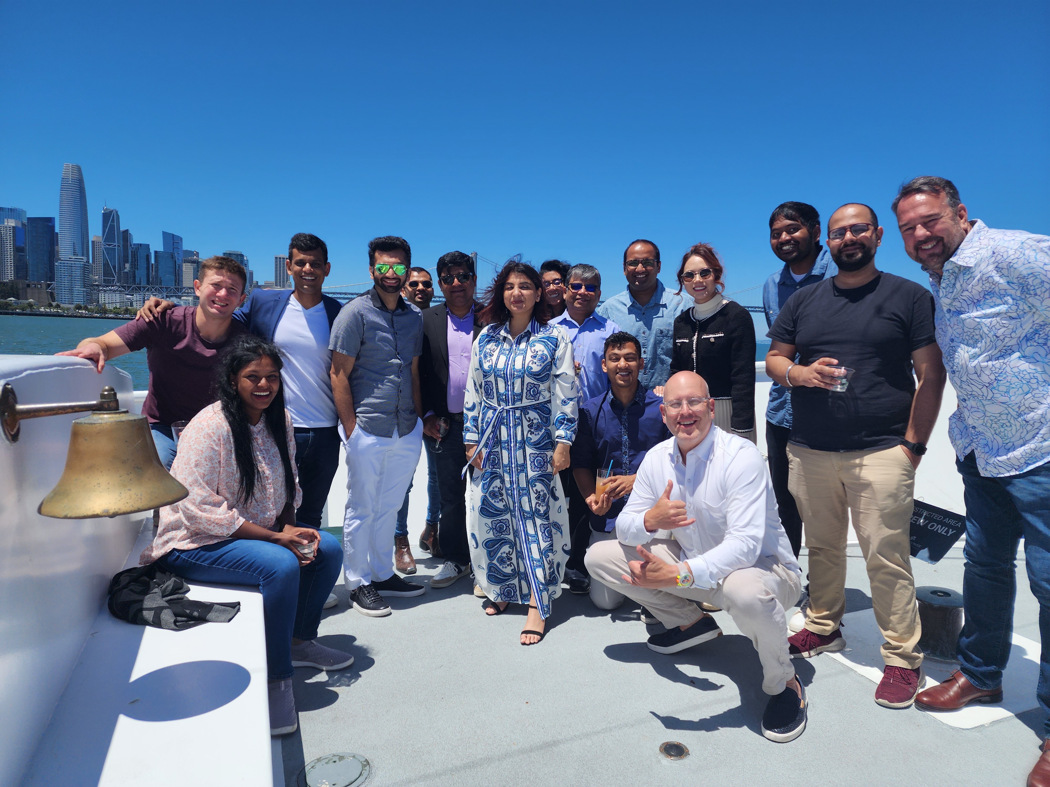image of the kloudfuse team on a boat with the skyline of the city behind them