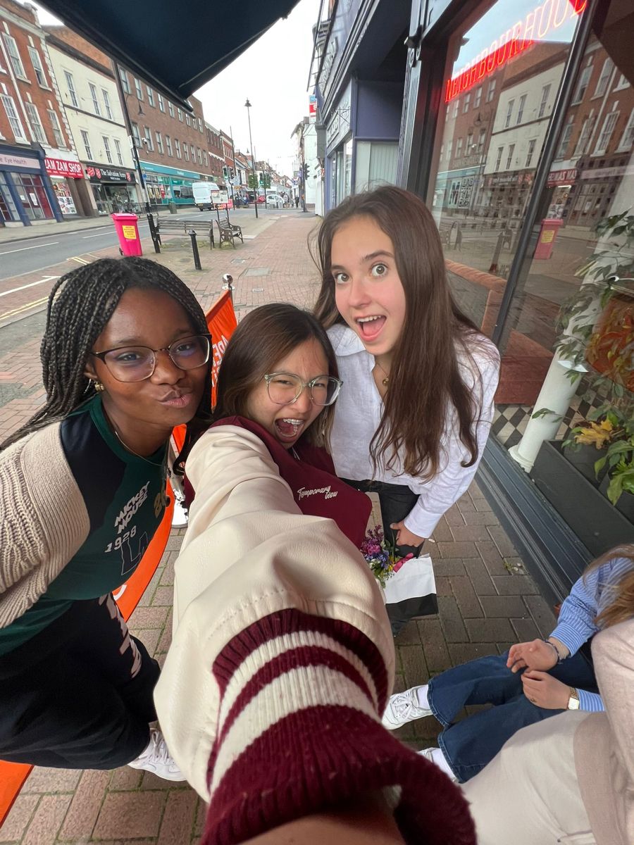 man in white and brown striped shirt smiling