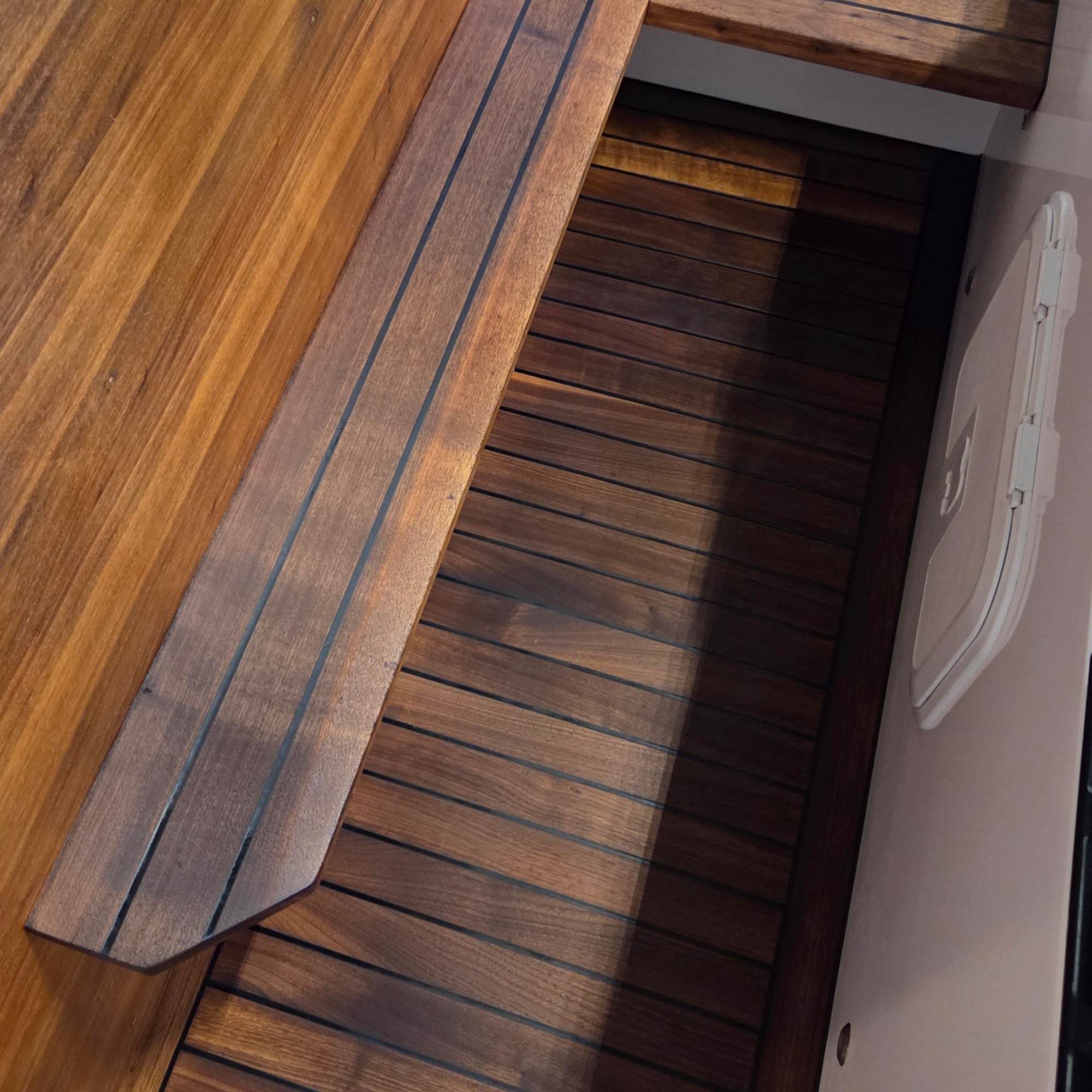 Freshly restored teak flooring in a boat
