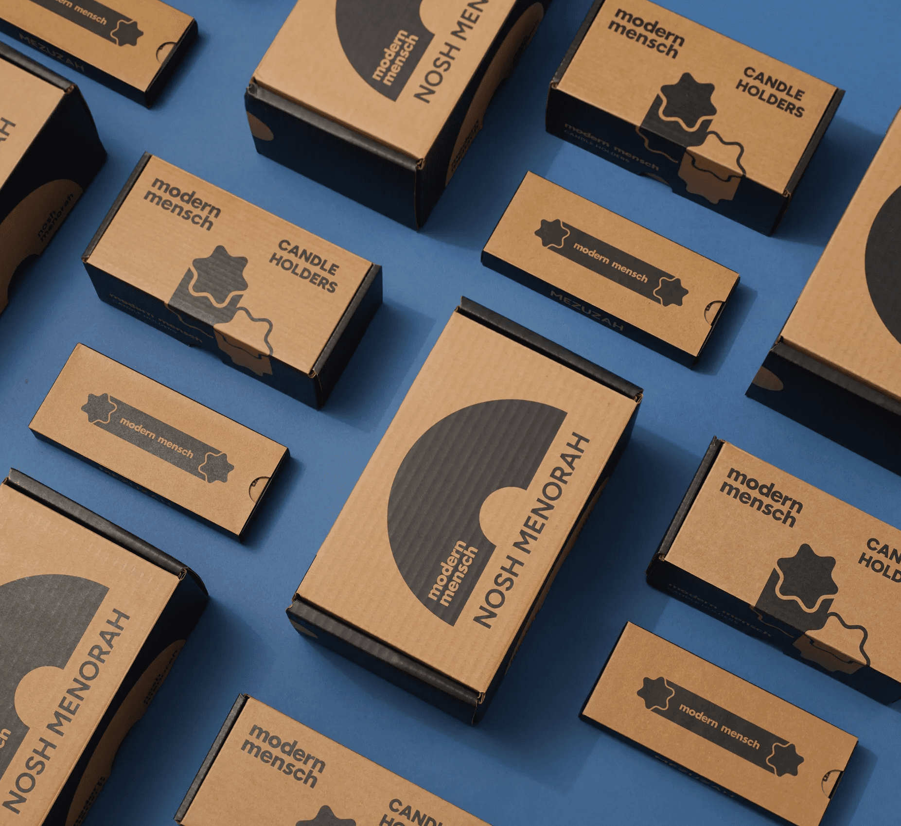 Modern Mensch product packaging system arranged on a blue background