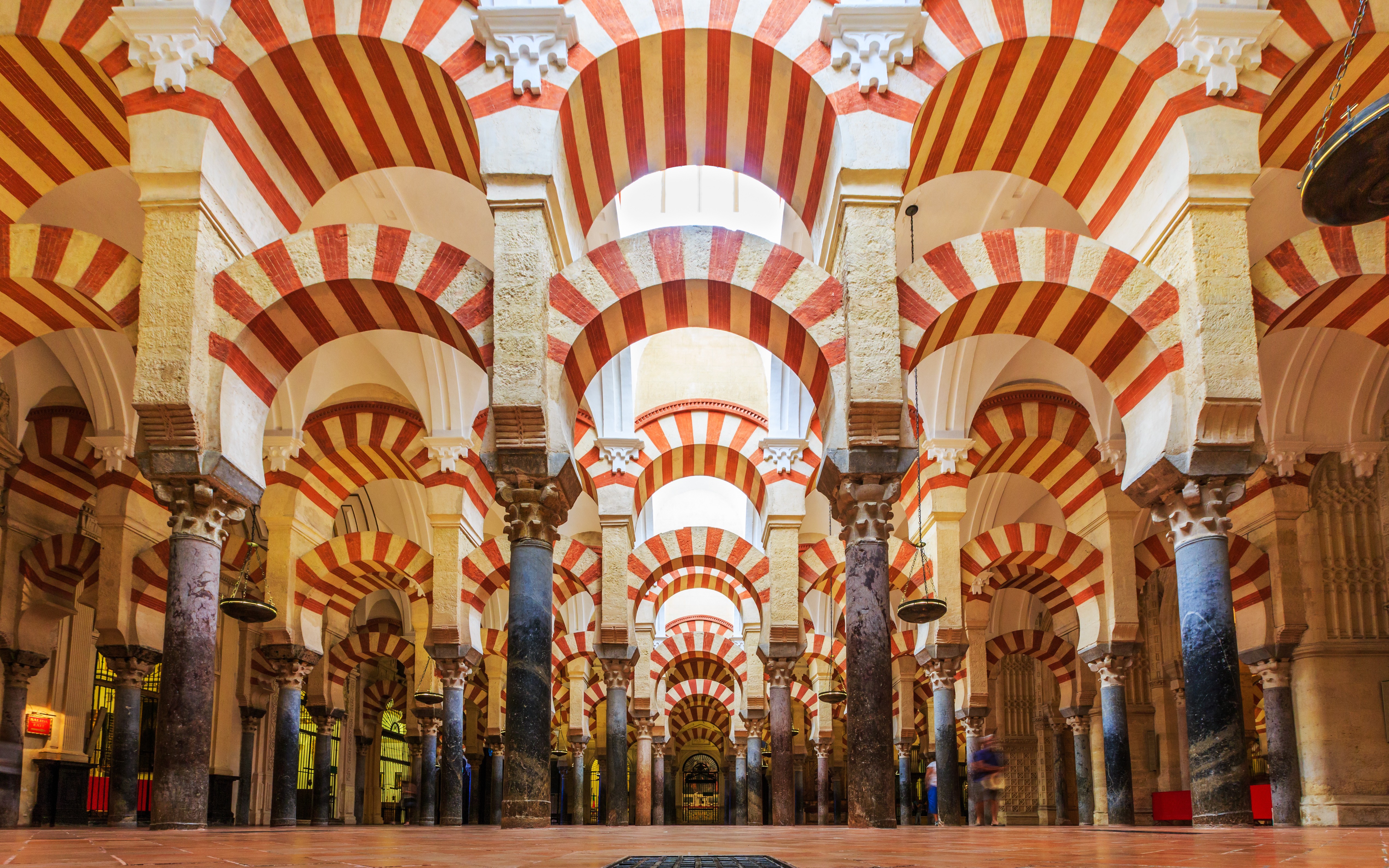 Córdoba Cathedral-Mosque interior with red and white arches and columns.