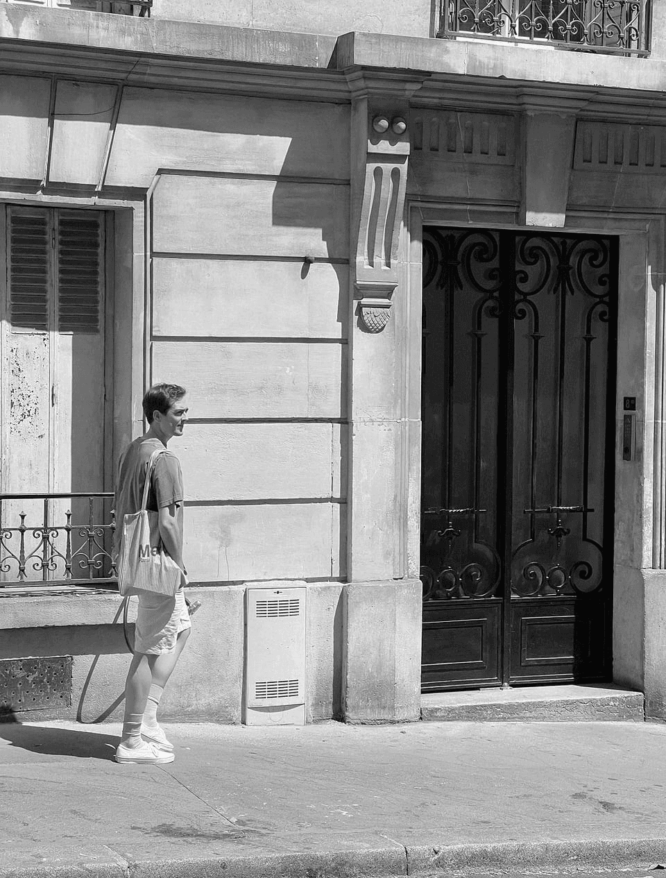 A photo of Jaime walking in the street.