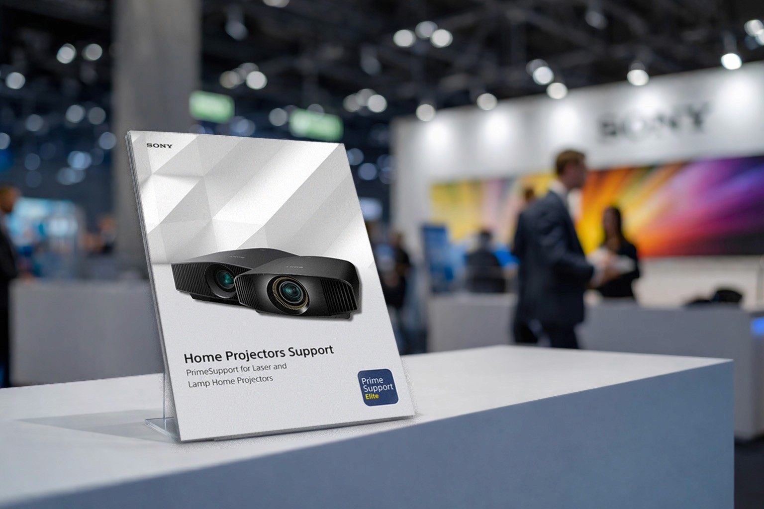 Modern home office setup with a monitor, ergonomic chair, keyboard, and indoor plants near a window with blinds.