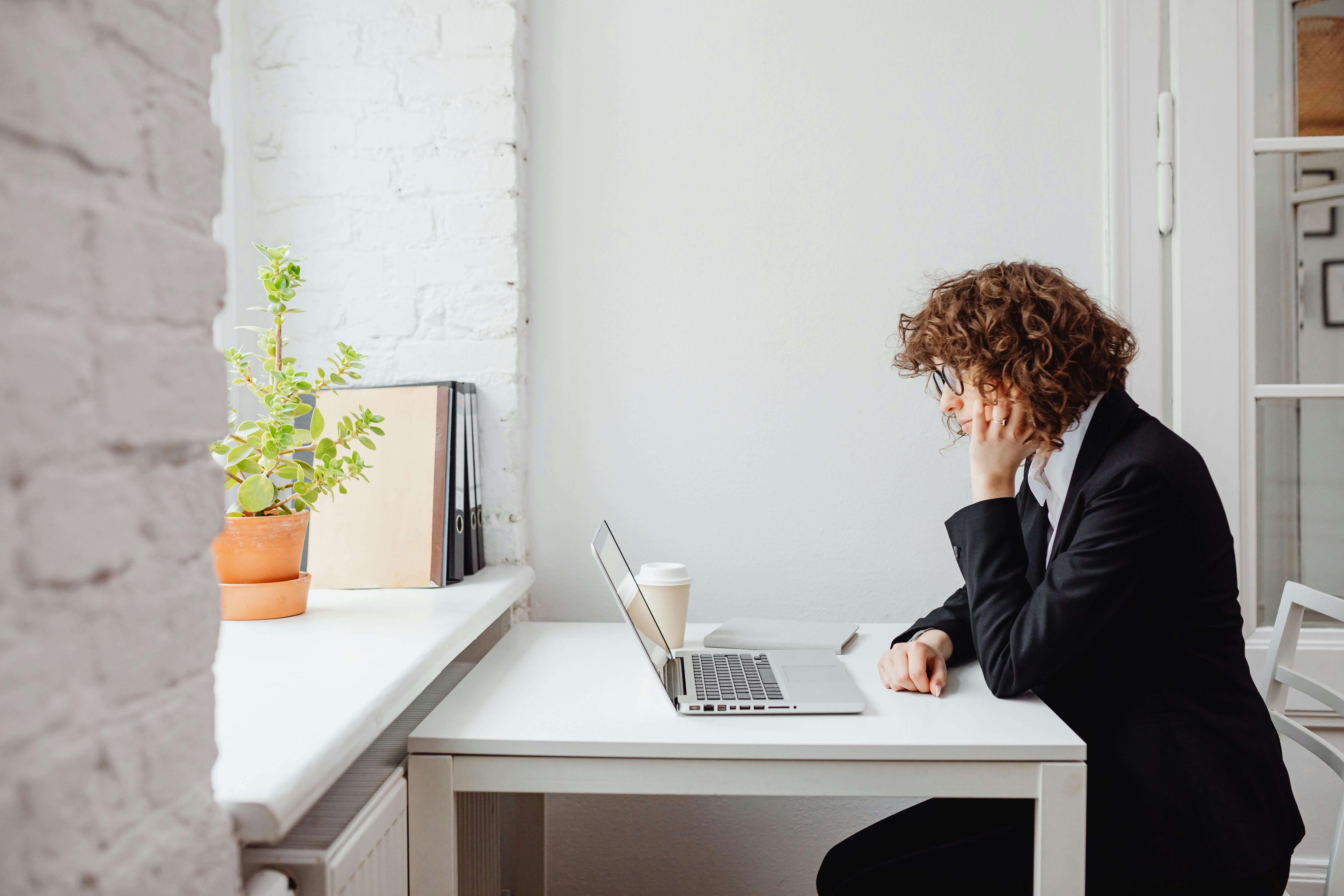 Woman reading about daily cold emails to find optimal number for success