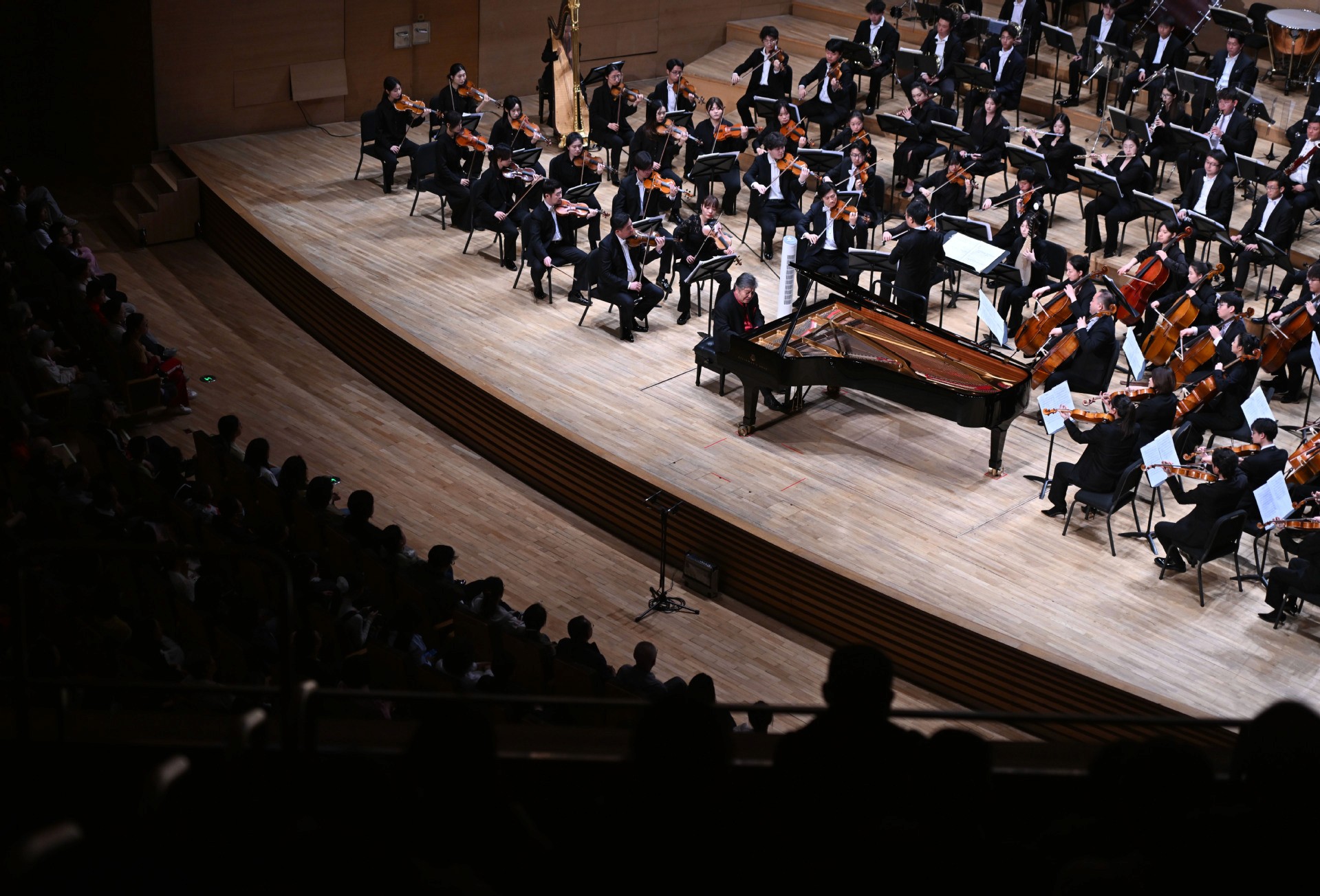 three people playing assorted instruments on stage