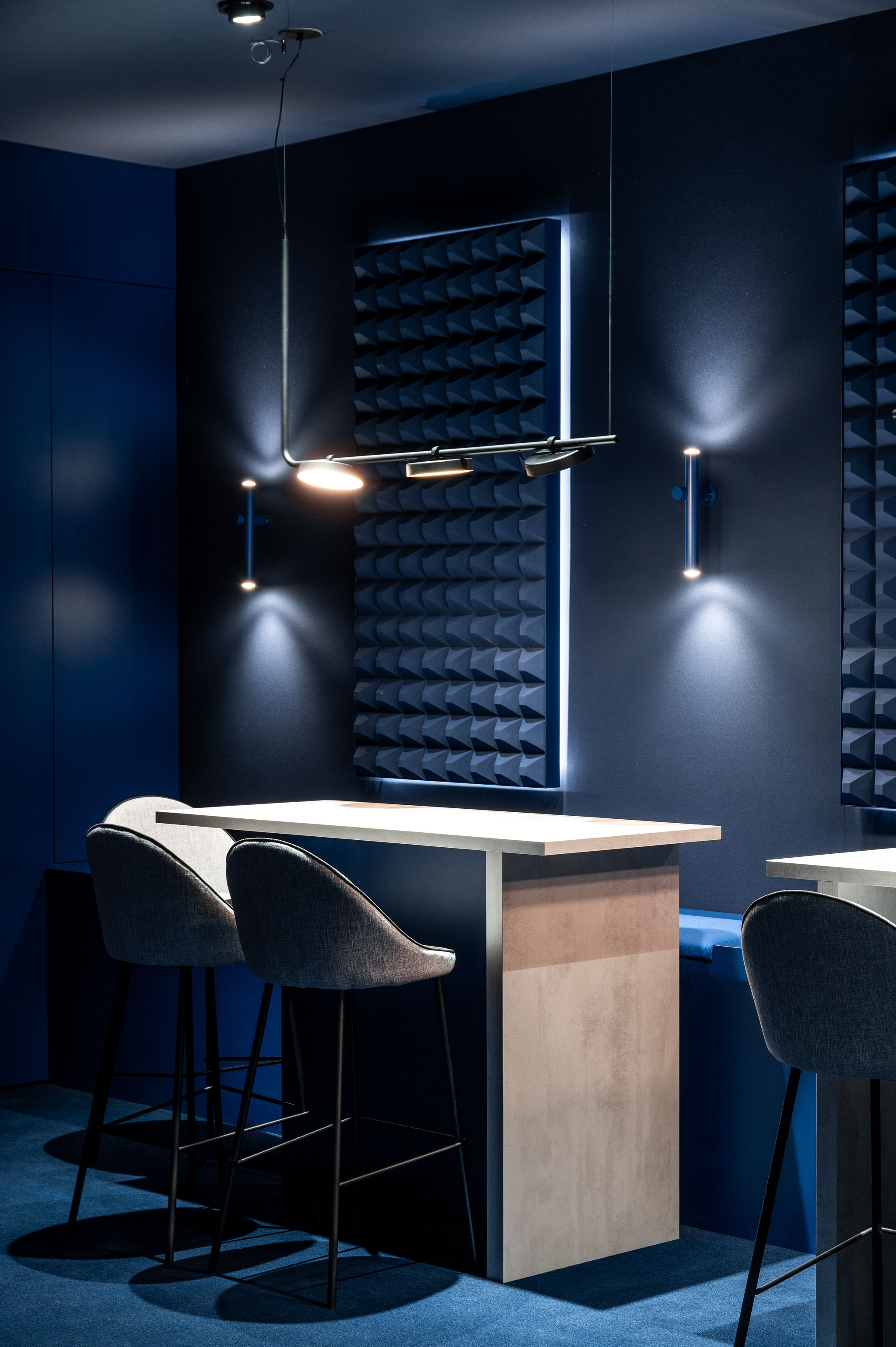 High table in concrete stickers material of the H. Moser & Cie design retail and creative  concept booth for the Watches and Wonders fair 2024 