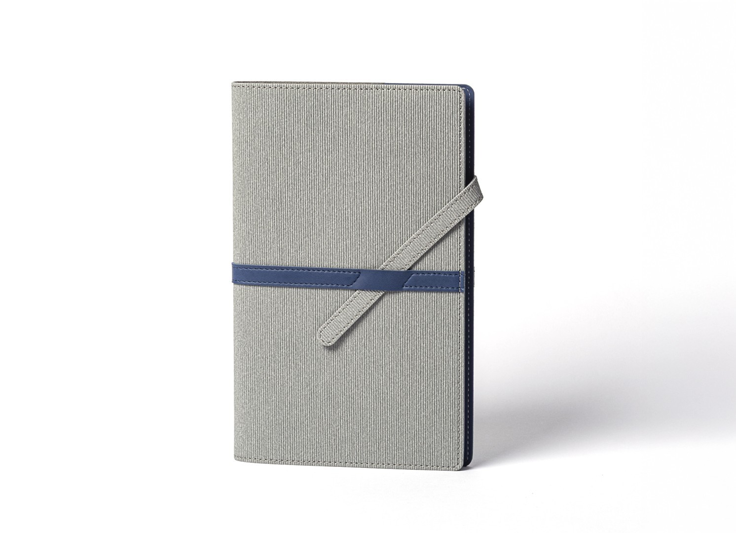 Front view of standing grey ribbed notebook with blue diagonal strap.