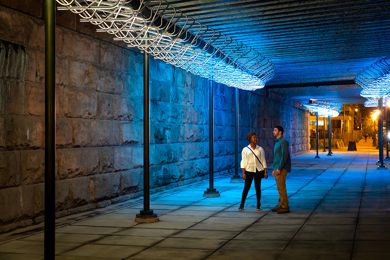 A ballerina with long hair throws her arms up