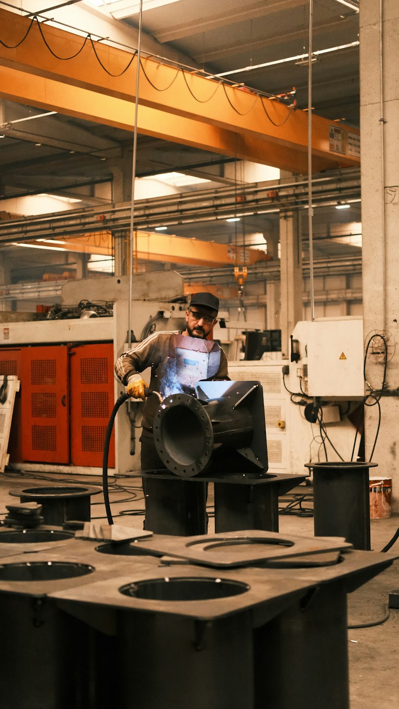 Factory worker operating industrial manufacturing equipment