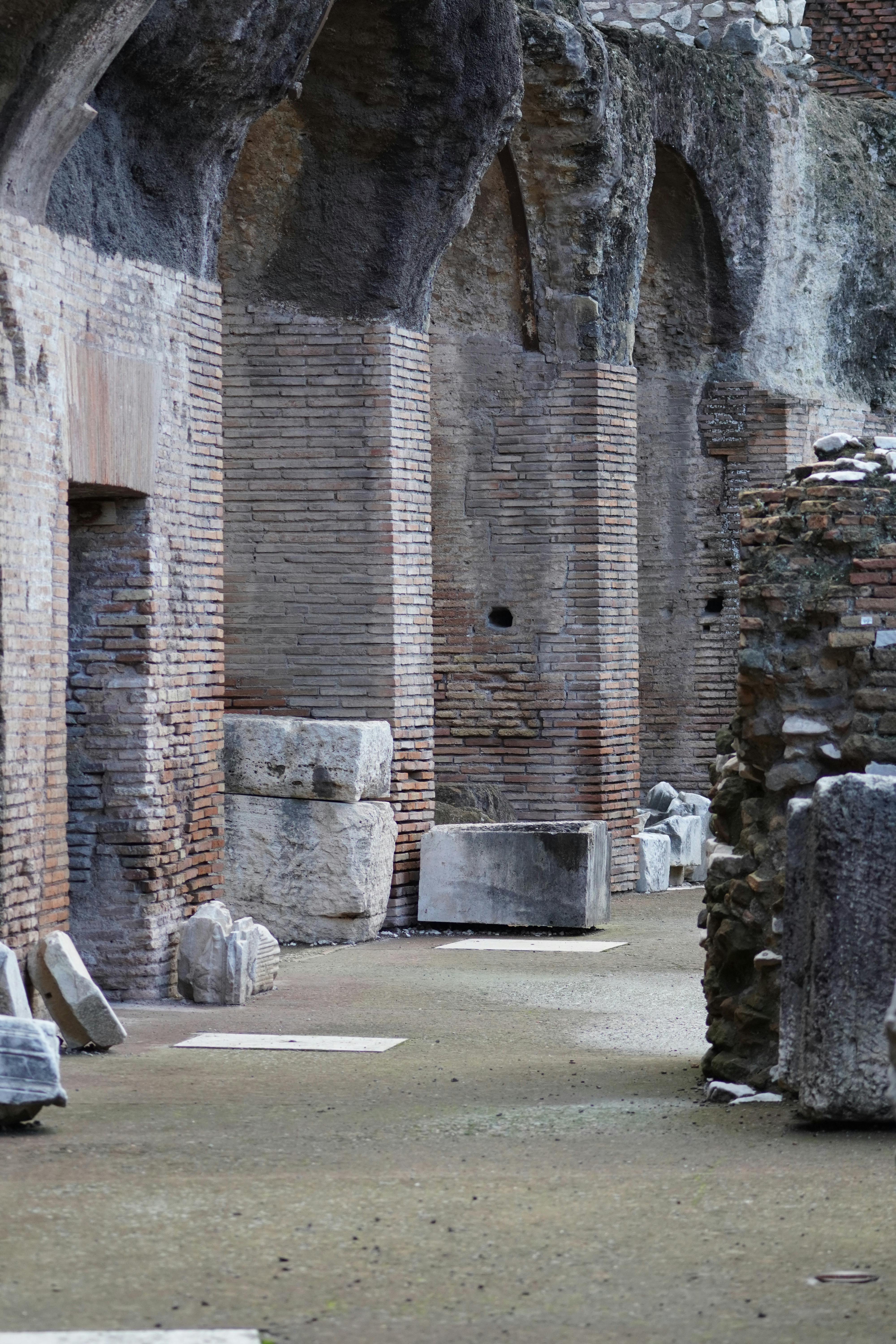 Brick columns and vaulted Roman walls inside the Domus Aurea archaeological site on Colle Oppio in Rome