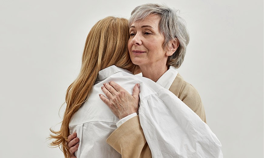 Elderly mother and daughter hugging