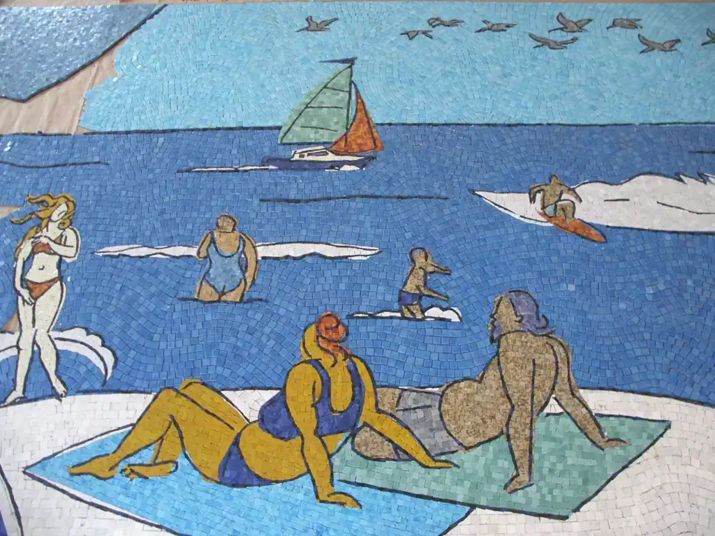 Mosaic mural depicting beachgoers and ocean scene at San Diego Airport.