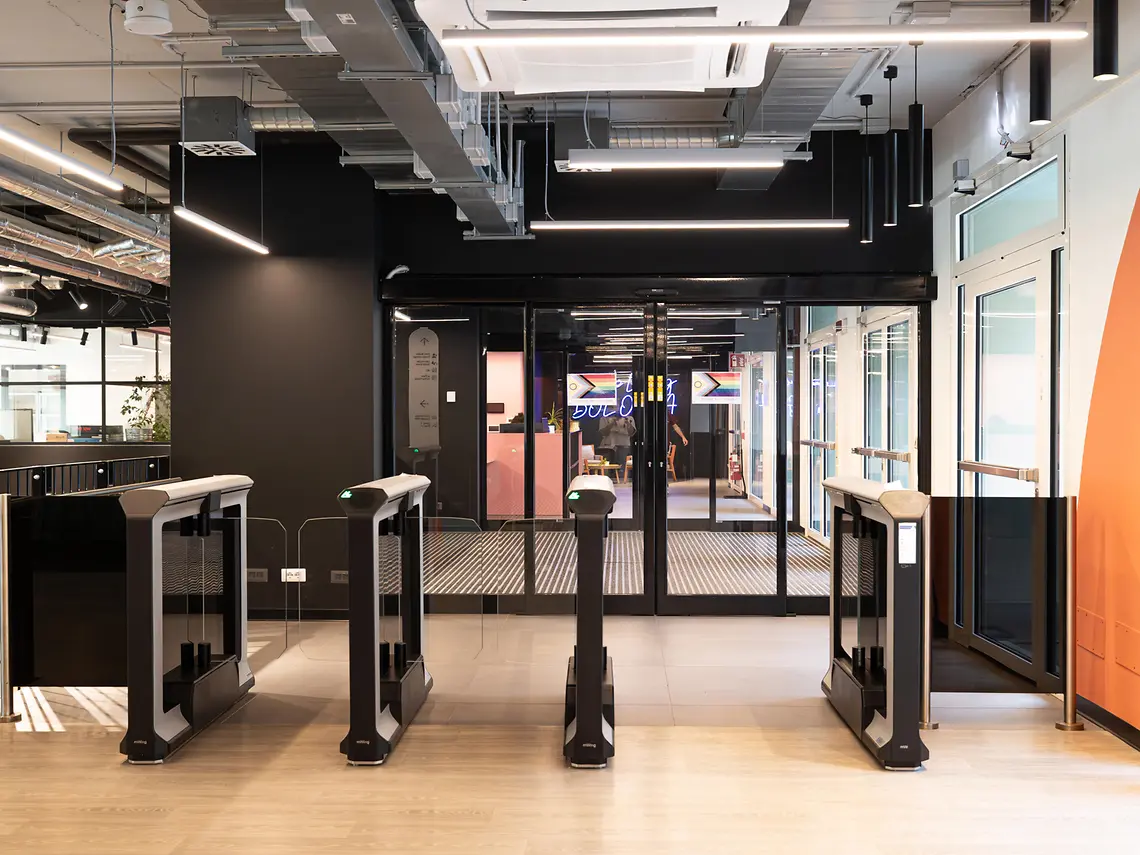 Secure reception with keycard-access entry gates at a student accommodation in Bologna