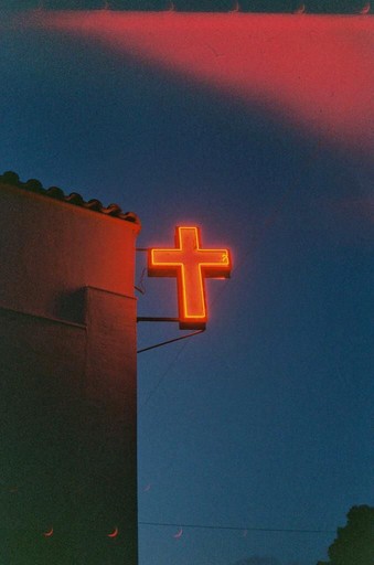 a woman standing in front of a crowd holding a microphone