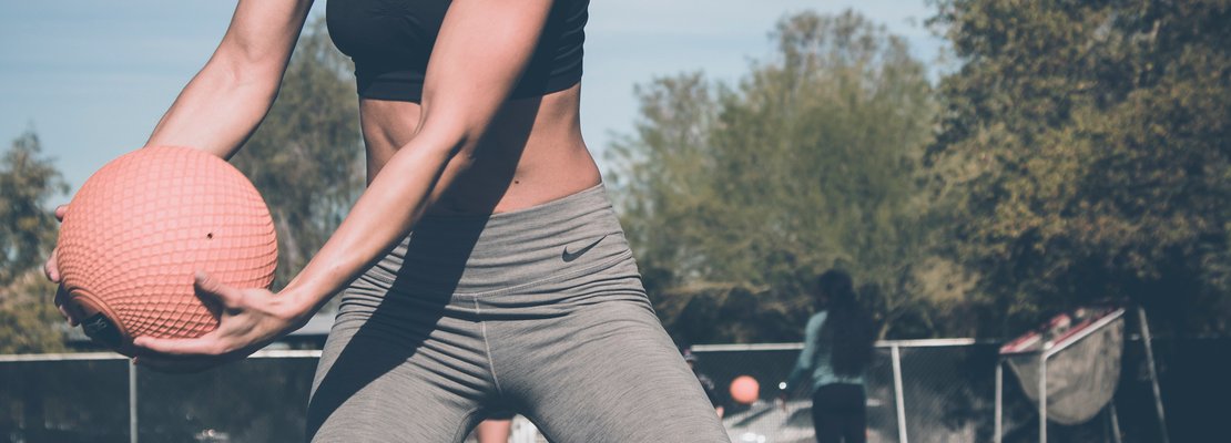 A woman holding a medicine ball