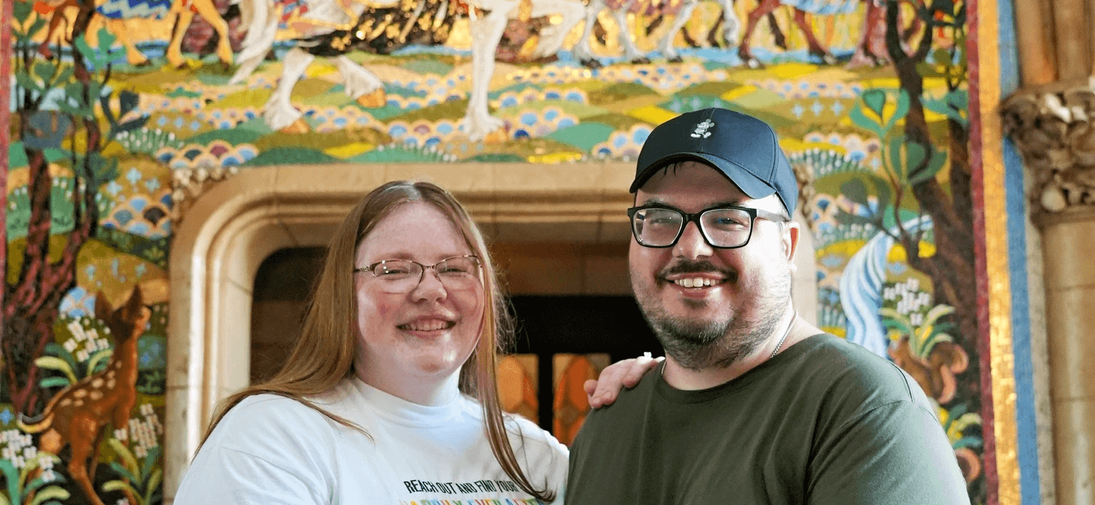 person sitting on grass and using phone