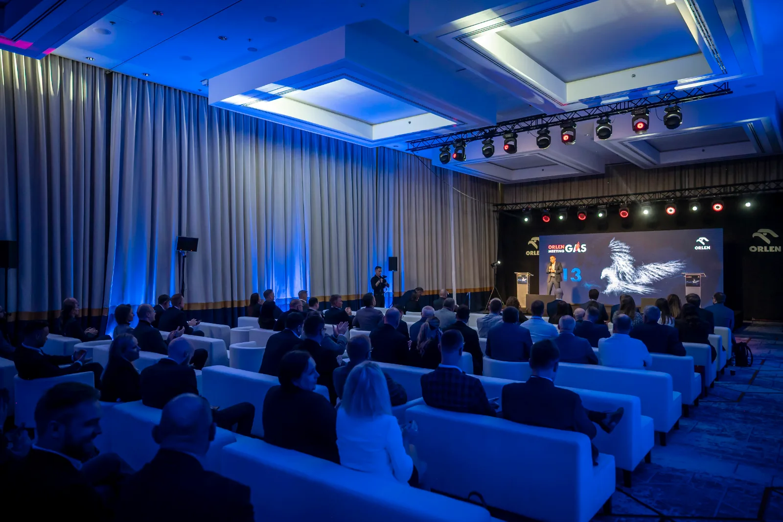 Panoramic photo of a B2B gala and conference with an audience and stage