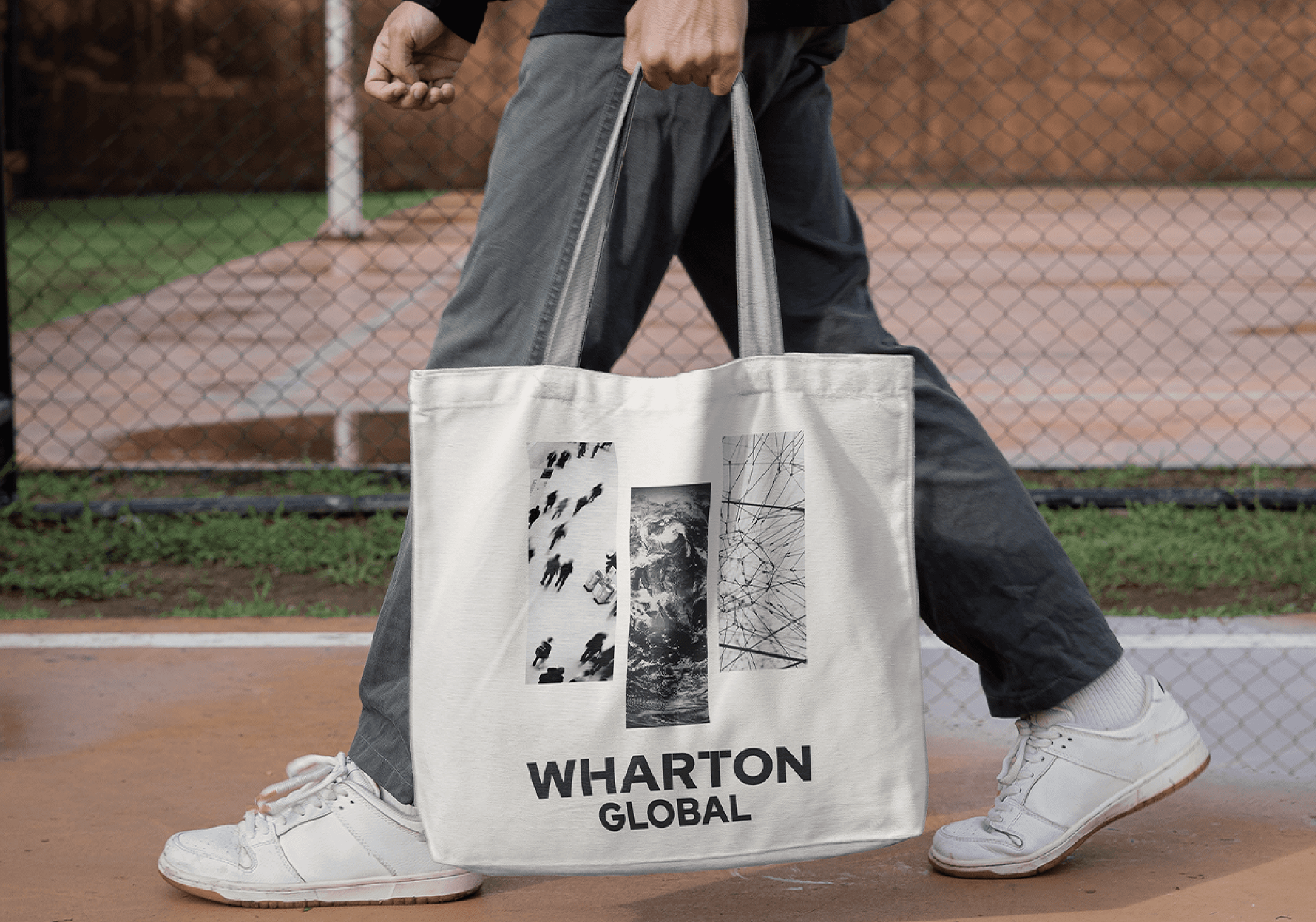 Person carrying a tote bag with the logo on