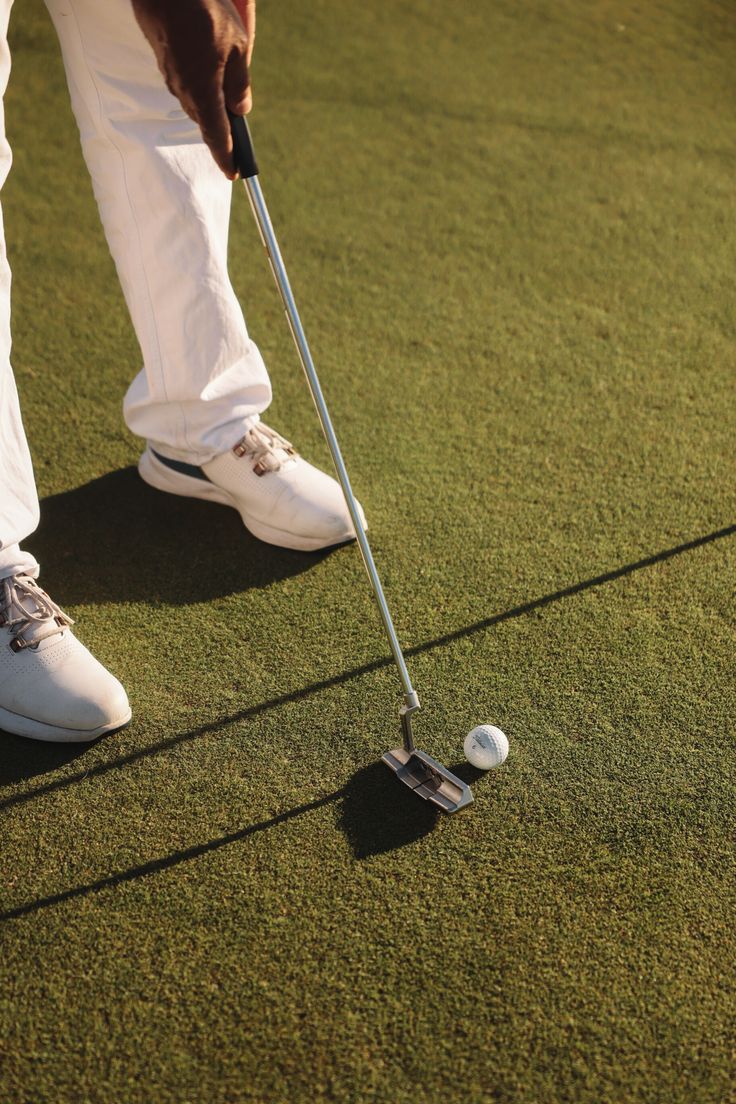 a man wearing sunglasses standing in front of a boat