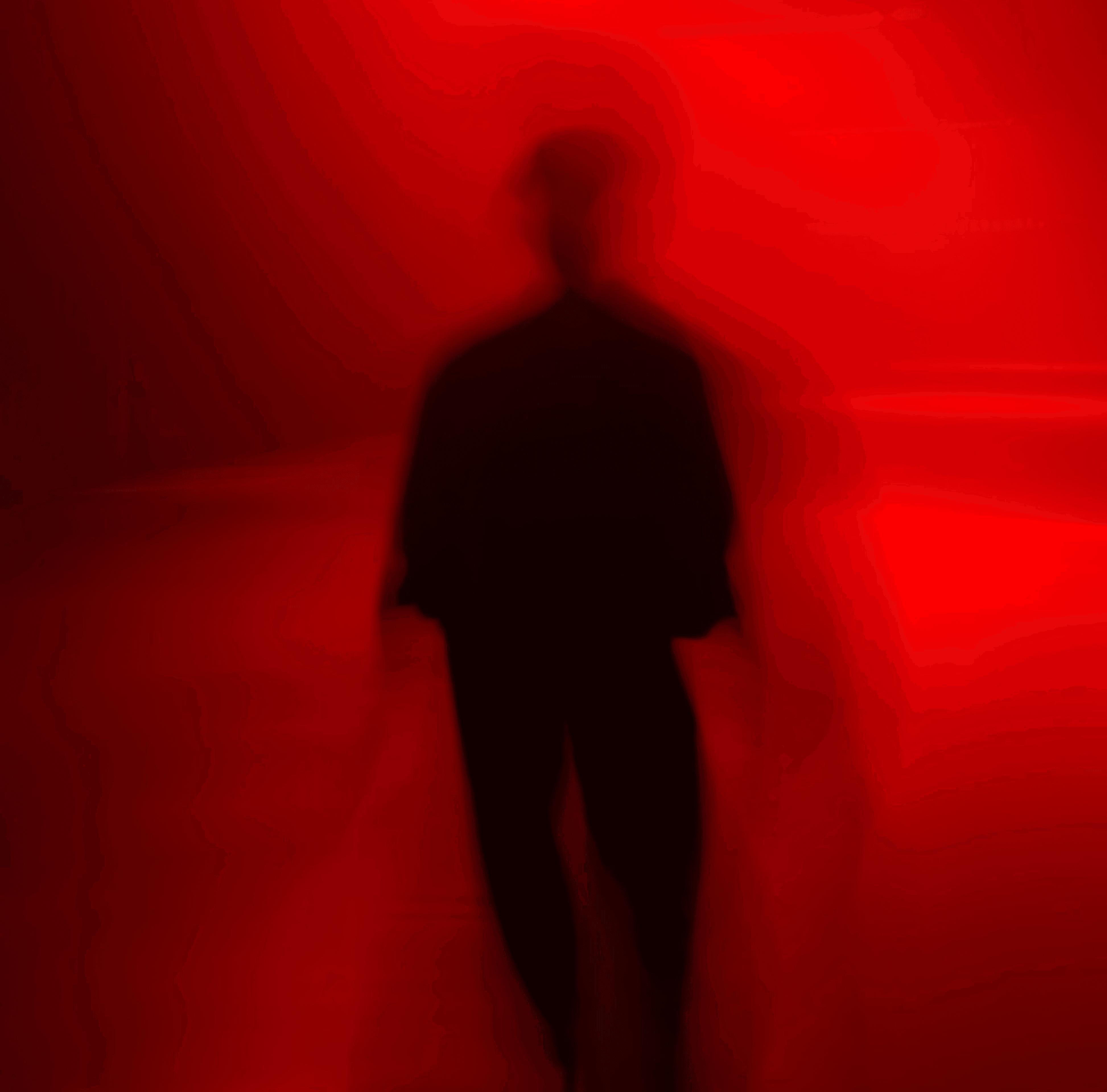 a blurry photo of a person standing in front of a wall