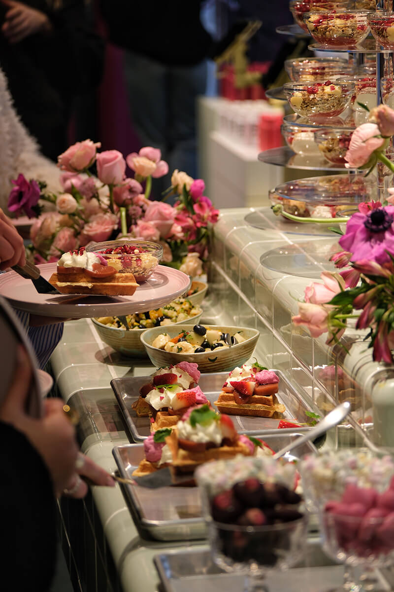 Several dishes placed together on a table with flowers
