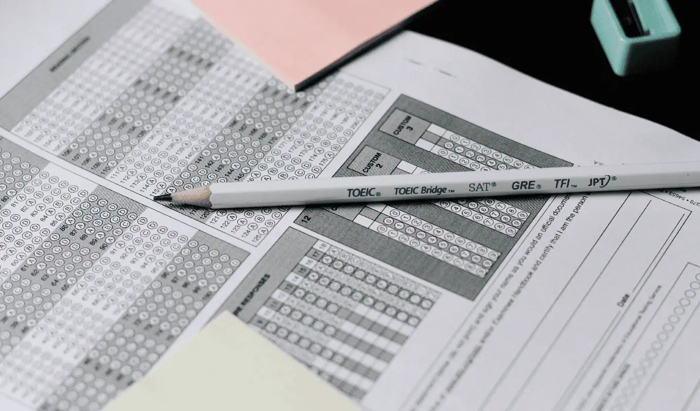 gray and white click pen on white printer paper