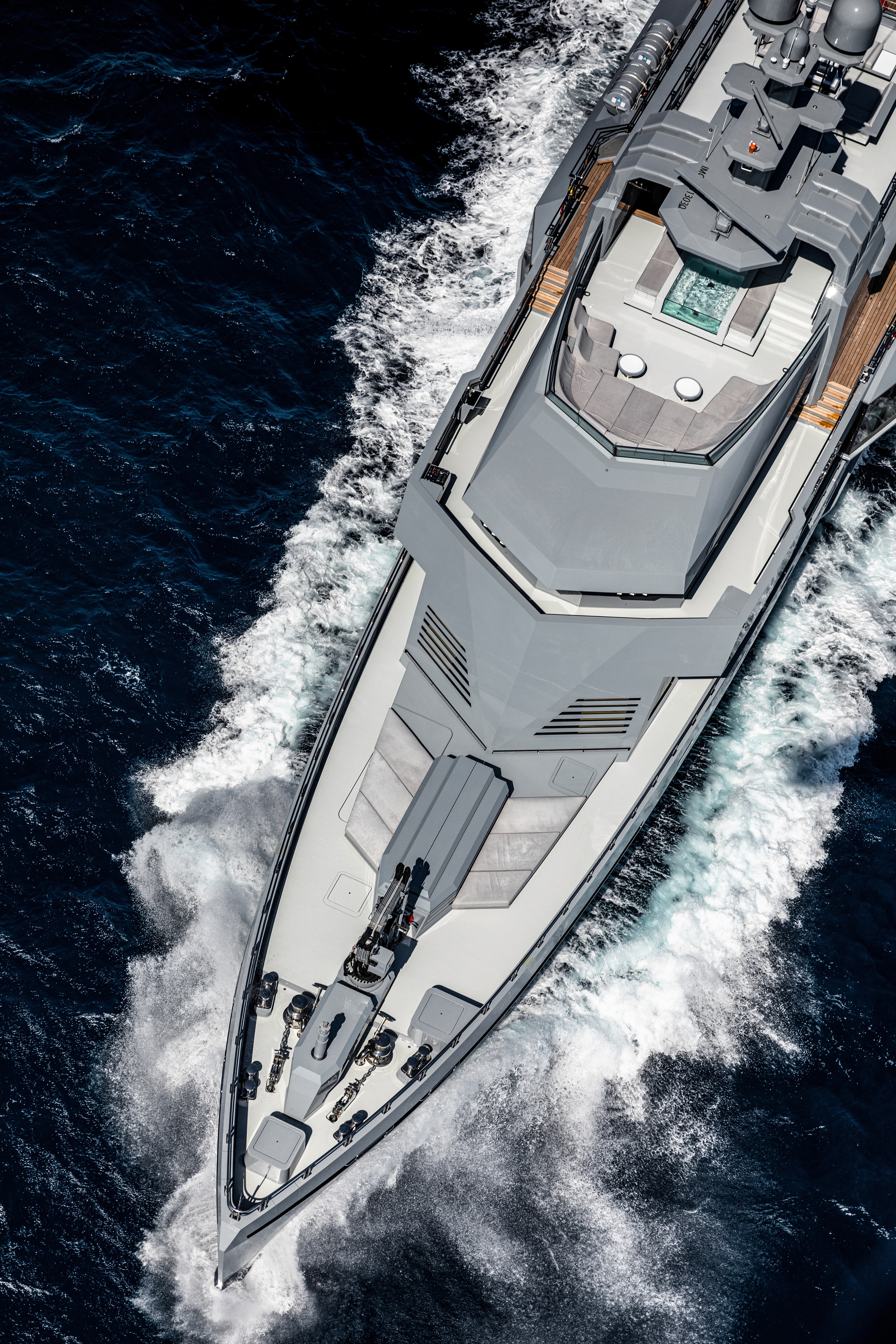 Sunlit orange chair on wooden floor near staircase.