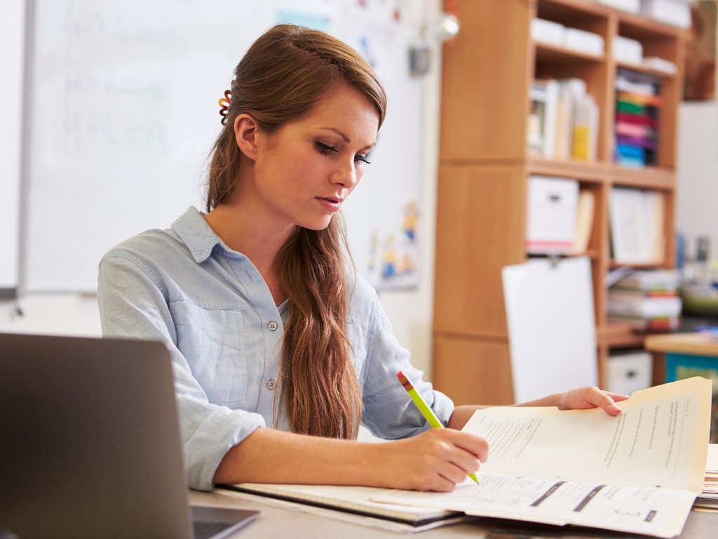 woman using documents - Report Writing Examples