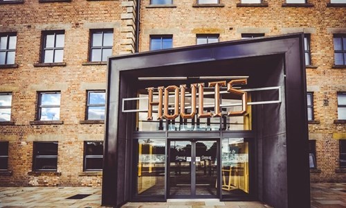 Photo of Houtls yard enterance, showing a large factory enterance with a large sign that says 'HOULTS yard'