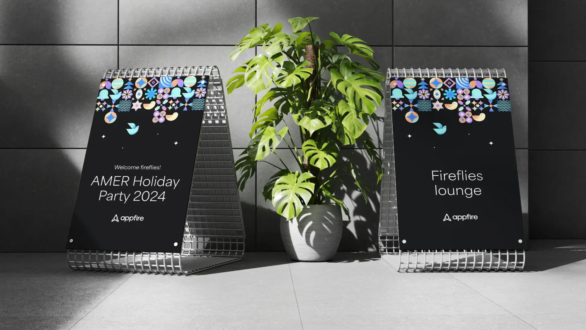 A photo of two signboards on either side of a large green plant in a contemperary office setting