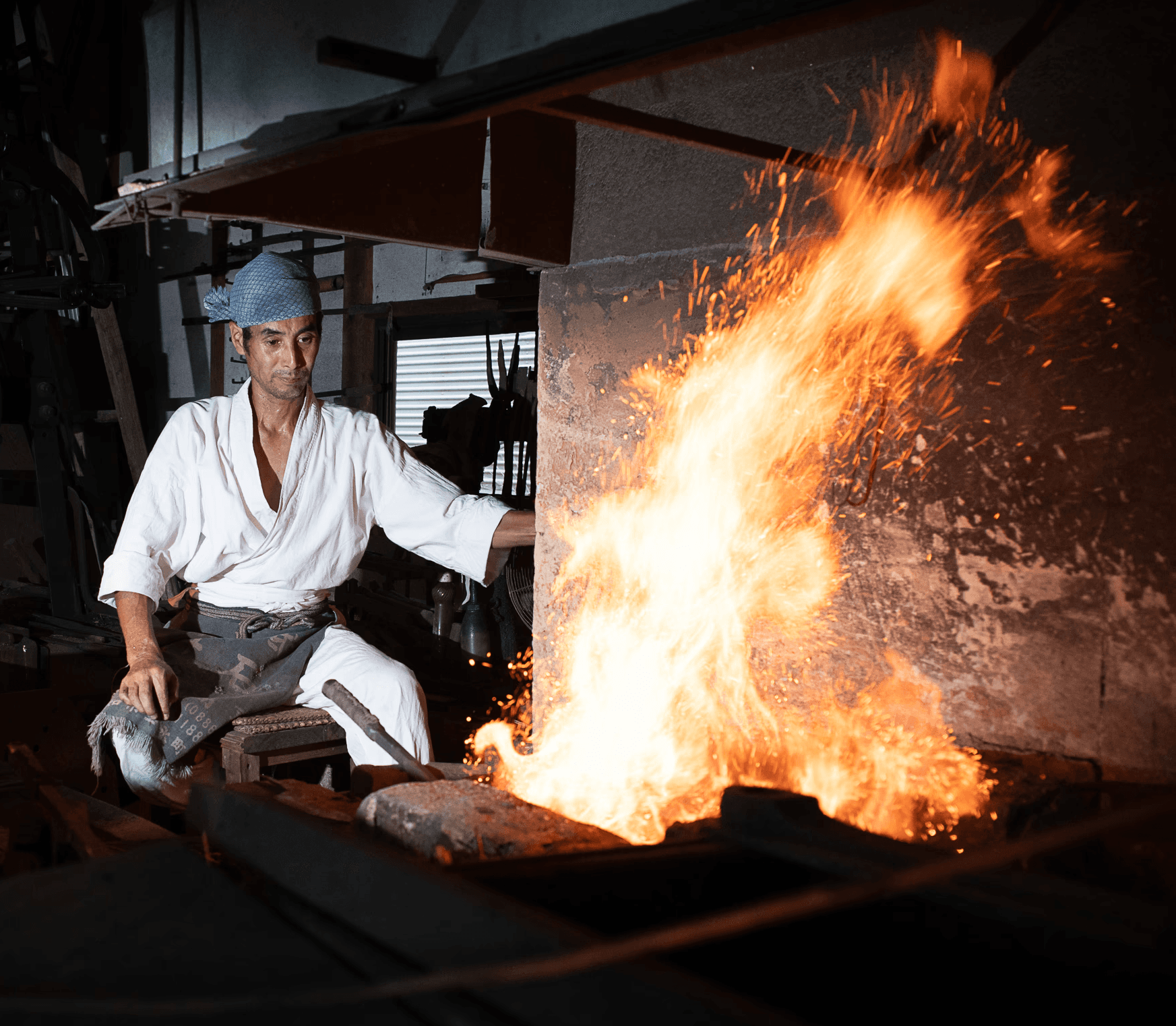 Swordsmiths hammering iron in a team
