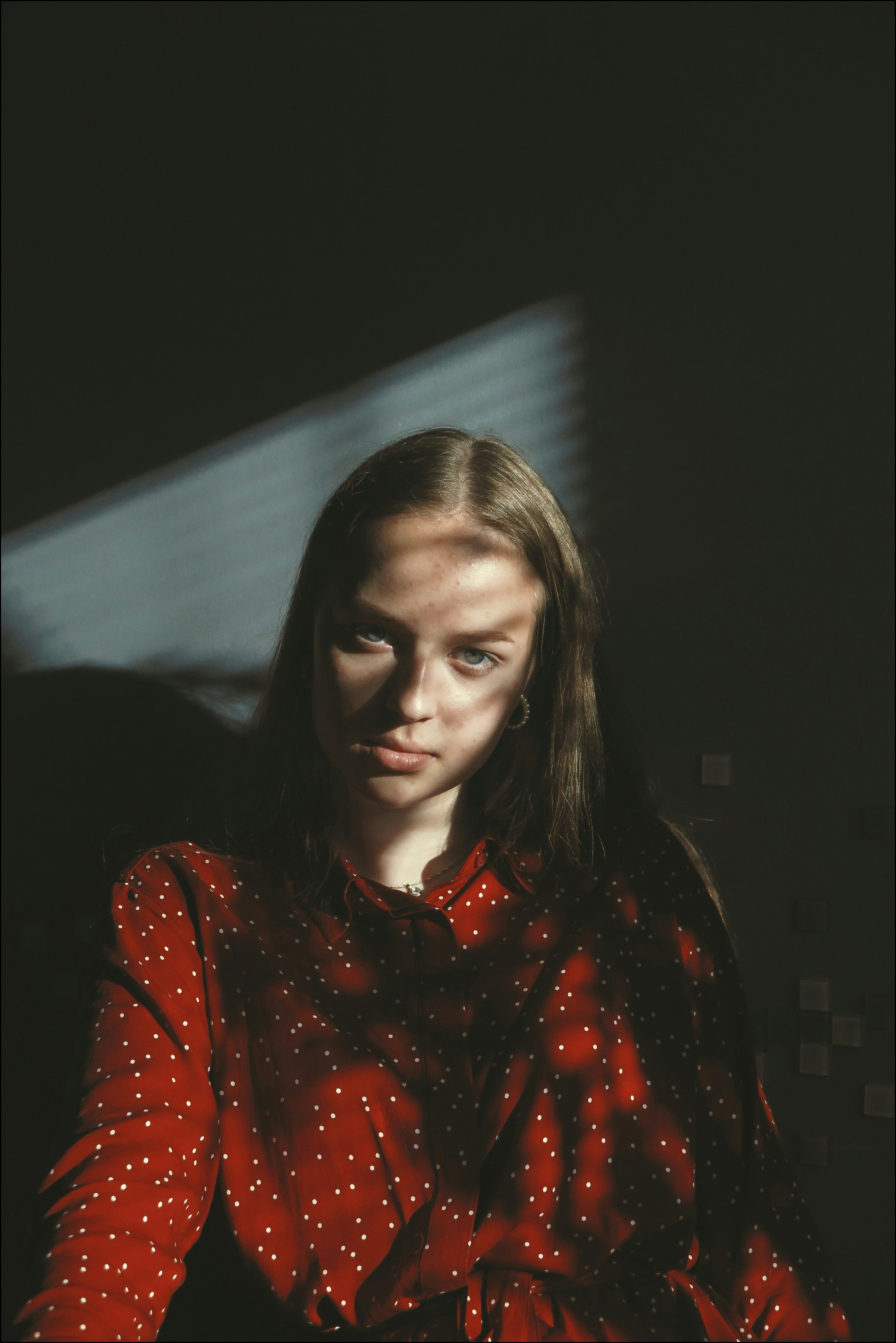 woman in red and black polka dot long sleeve shirt