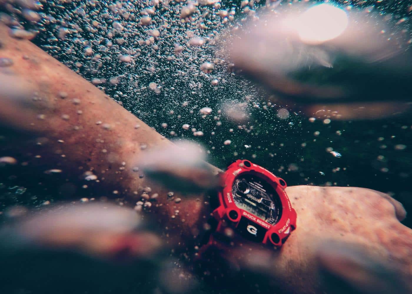 Man waering a waterproof swim watch underwater