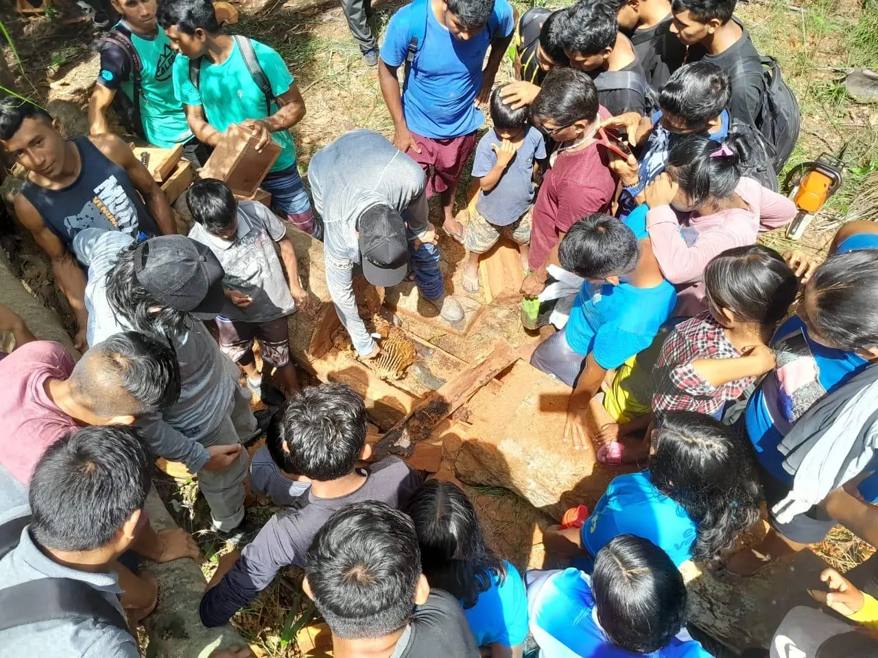 Grupo de pessoas reunido em volta de uma melgueira.