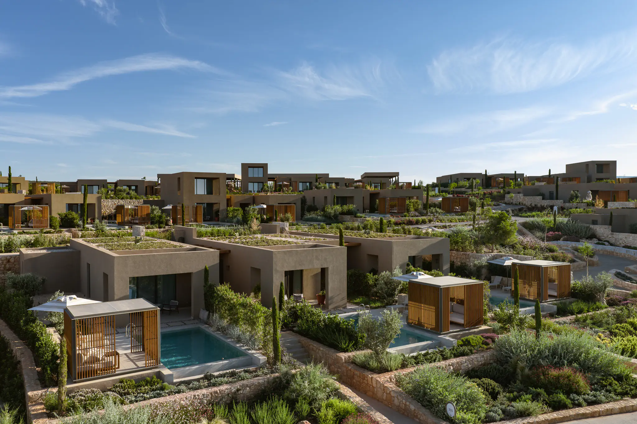 Low aerial view of the villas set among gardens