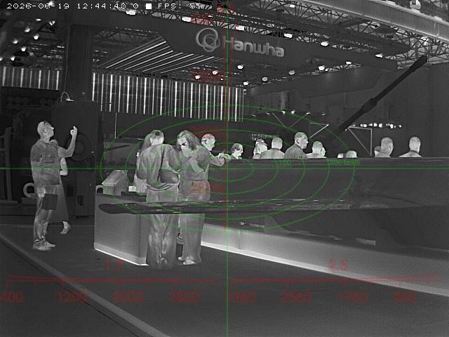 LWIR thermal capture — defense expo floor, ranging reticle