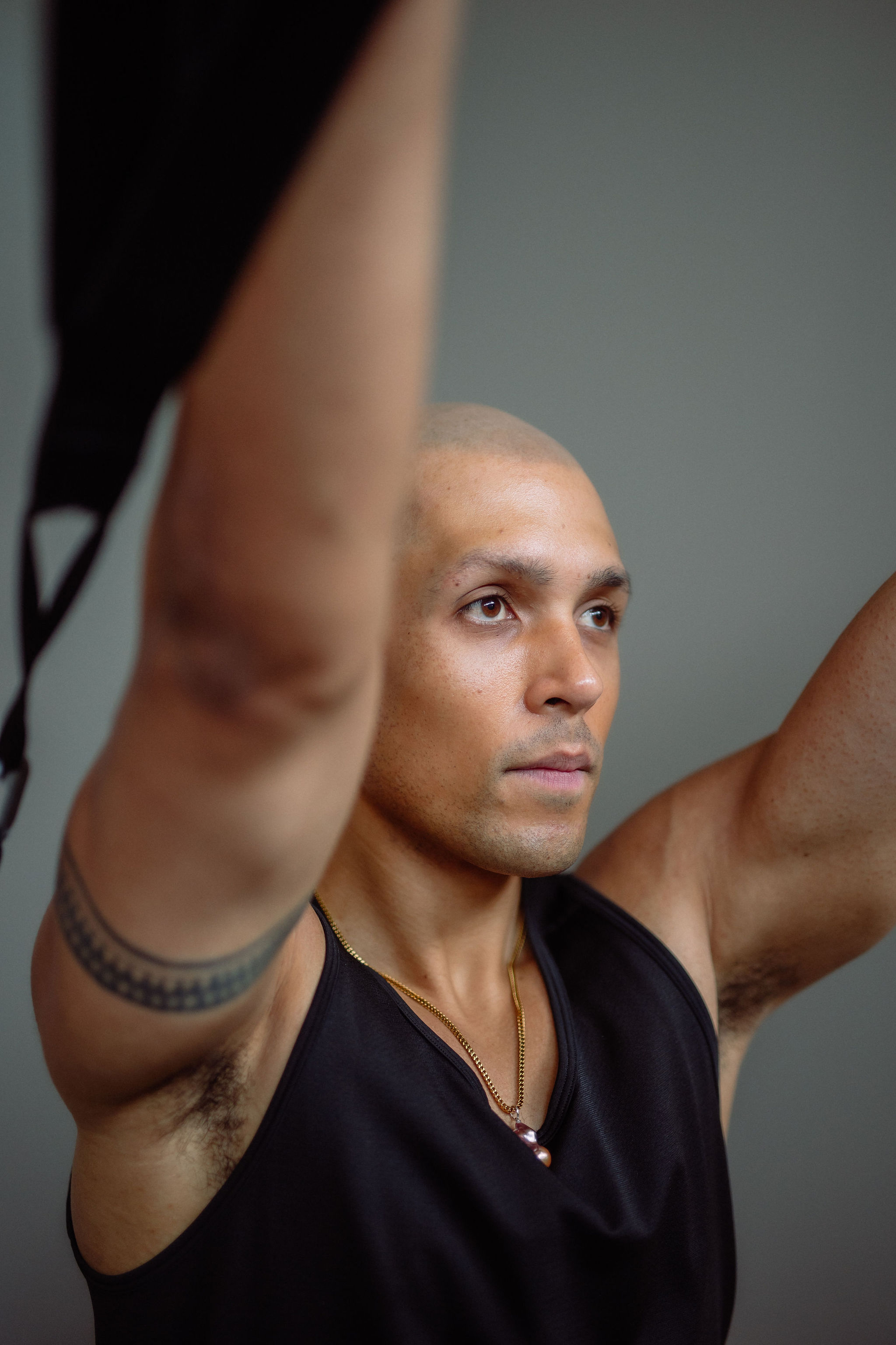 Black cosmetic product bottle against a dark background