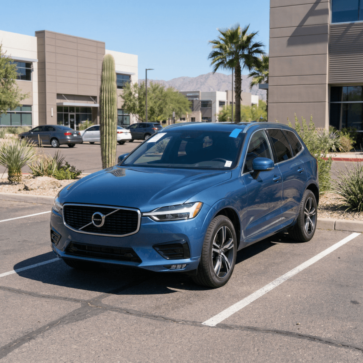 Mobile windshield repair on a blue Volvo XC60 at a Tempe, AZ business park parking lot