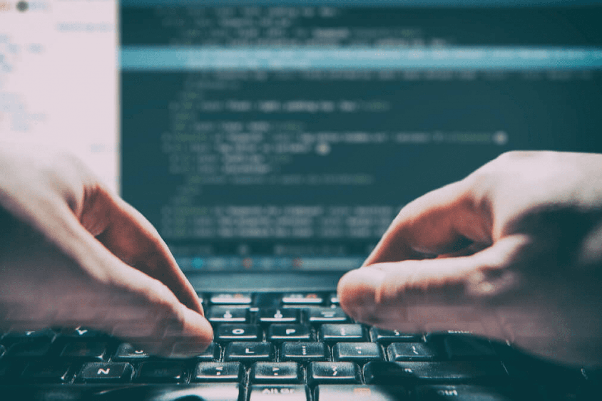 Hands typing on a keyboard