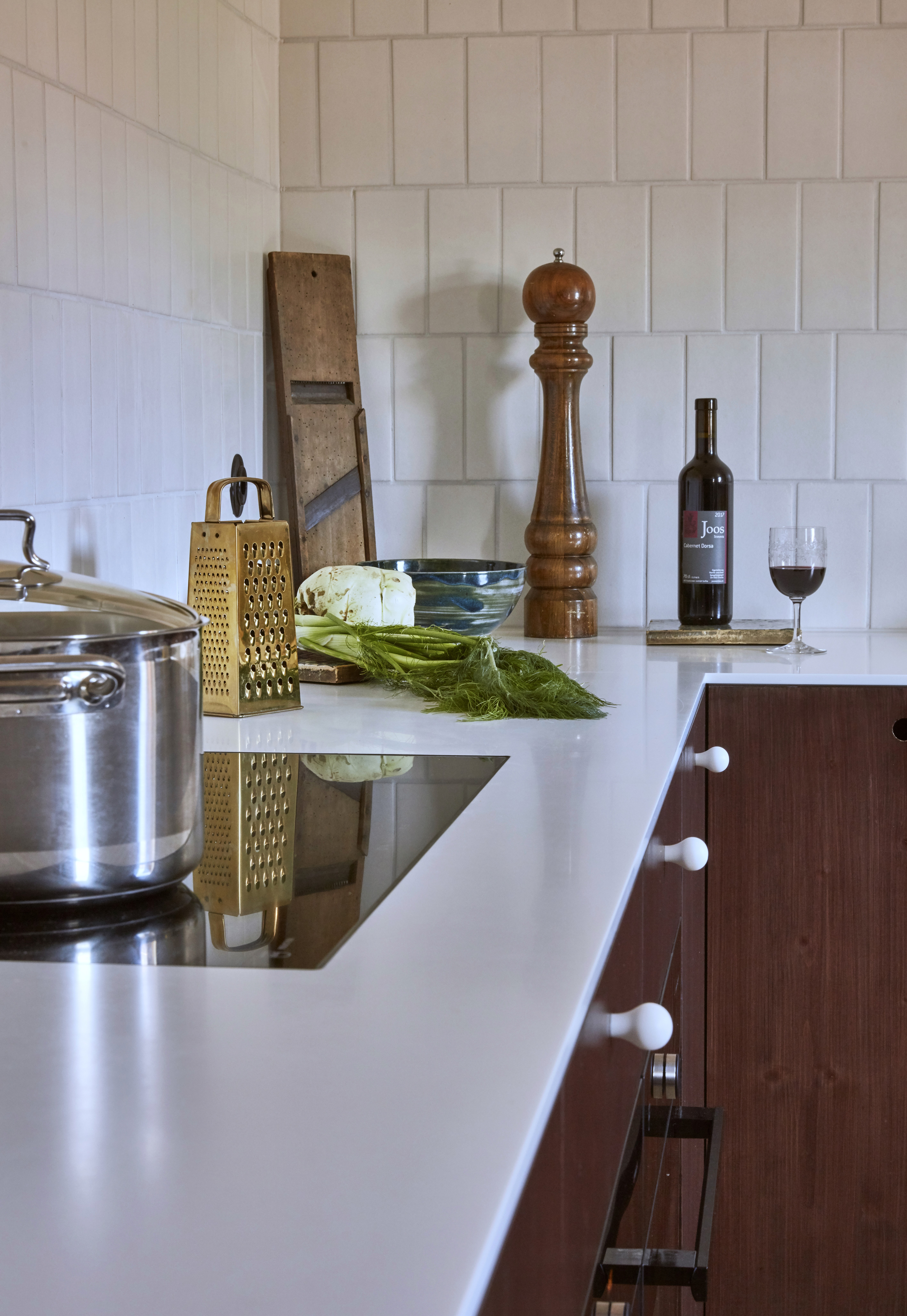 A kitchen with a white top and a pot on the stove.